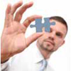 Educational Psychology, man looking at the puzzle piece between thumb and forefinger
